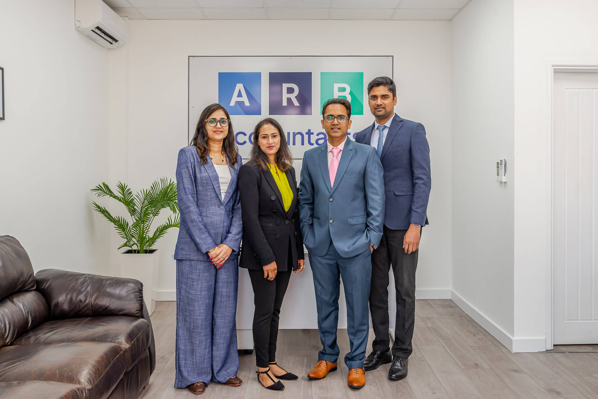 ARB Accountants team standing together in front of the company logo