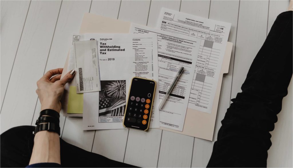 Image illustrating steps to file taxes for free, featuring a checklist and a computer with tax software open.